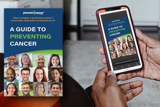 A close-up image of a person holding a smartphone. The screen has an image of the Prevent Cancer Foundation Guide to Preventing Cancer on the screen.