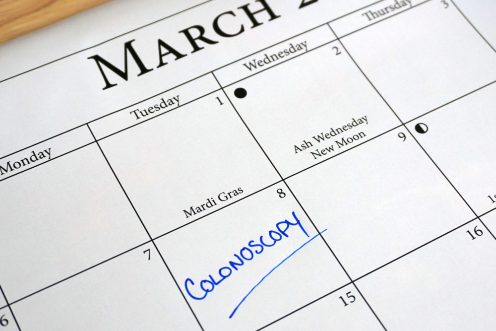 A March calendar with colonoscopy written on one of the days
