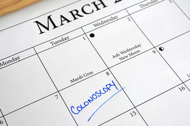 A March calendar with colonoscopy written on one of the days