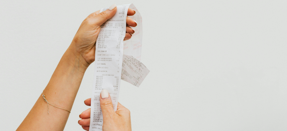 Hands hold a long receipt